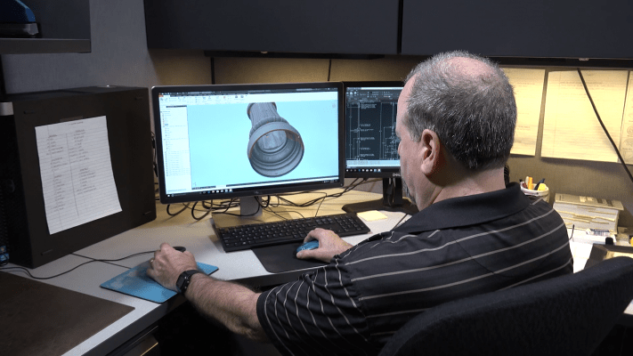 3D Design Engineer looking at computer monitor