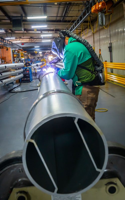 Welder welding I-Chamber pole